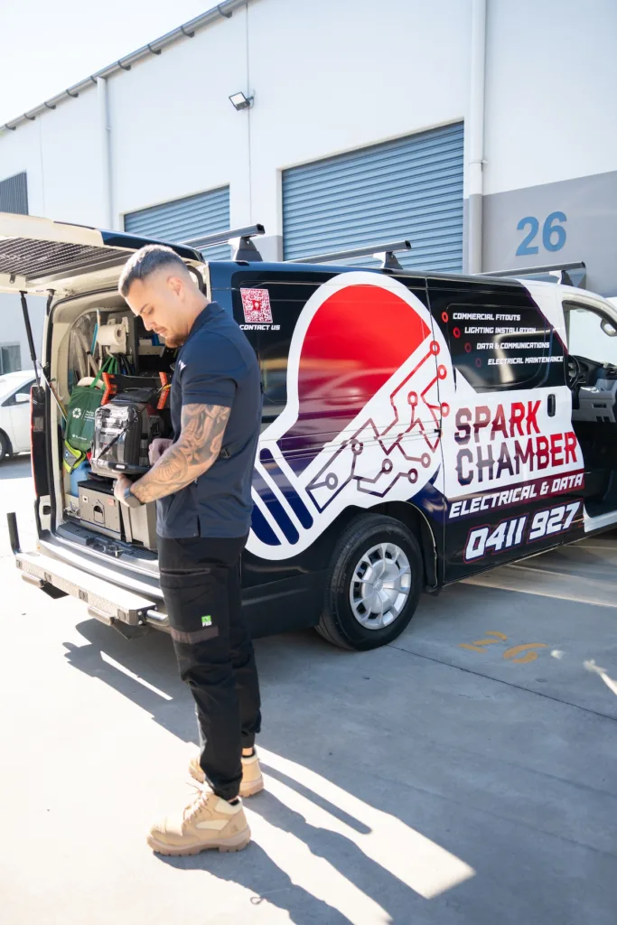 Spark Chamber electrician unloading tools from the van