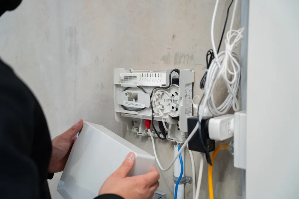 Spark Chamber electrician checking wall-mounted equipment