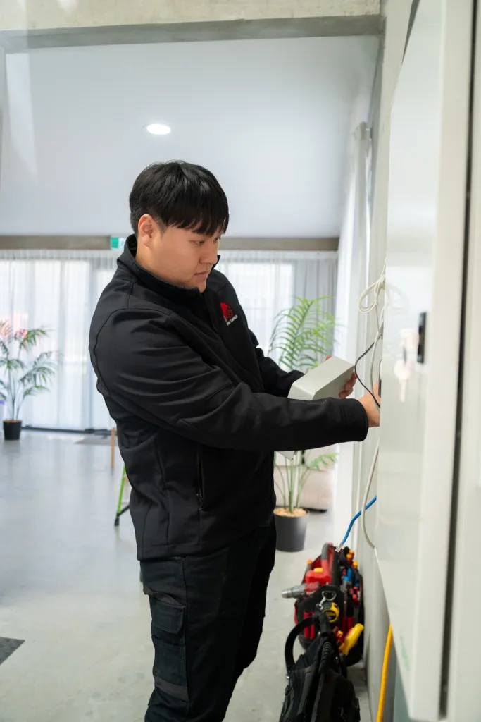Spark Chamber electrician checking job details on site